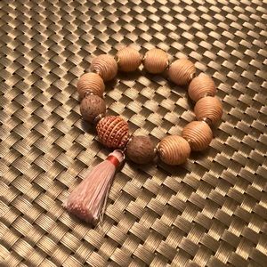 Beautiful beaded peach neutral bracelet with tassel